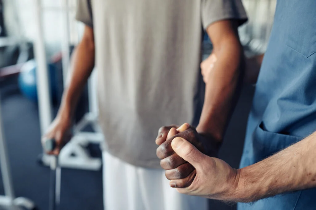 Doctor helping patient to learn walk